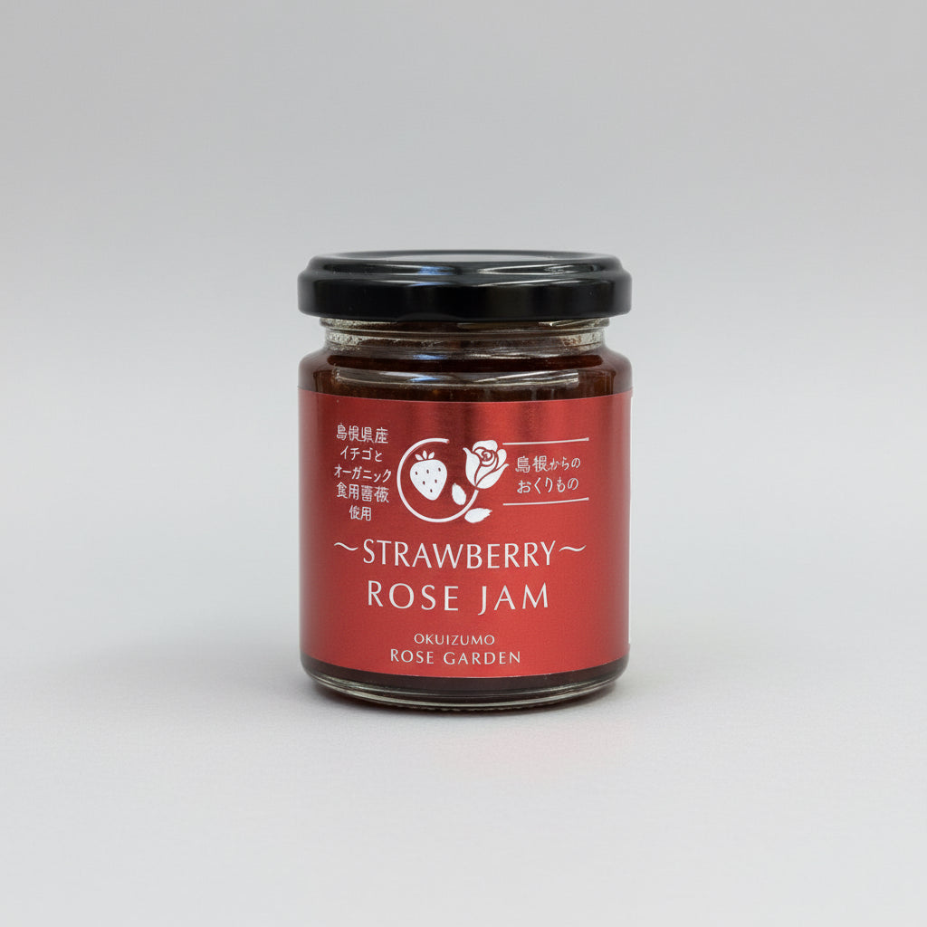 A jar of Okuizumo Rose Garden strawberry rose jam with label in Japanese and English, placed on a wooden surface.