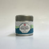 A tin container of Azuma Tea Garden's Kanaya Midori matcha, placed on a surface with natural lighting.